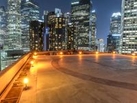 a bench on the ground at night with city lights on it's tops, while others of the rest below a city block