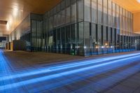 the light trail is being projected into the building at night, from which the lights are colored