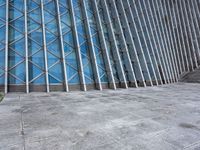 a view of a building from the outside with some windows and a bench next to it