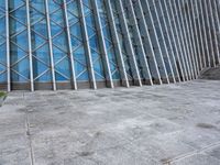 a view of a building from the outside with some windows and a bench next to it