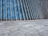 a view of a building from the outside with some windows and a bench next to it