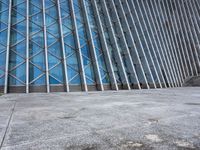 a view of a building from the outside with some windows and a bench next to it