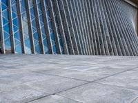 a view of a building from the outside with some windows and a bench next to it