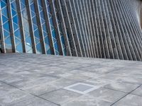 a view of a building from the outside with some windows and a bench next to it