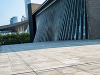 there is a skate board laying on the floor by a building with tall buildings in the background