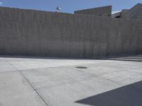 this is a picture of a large concrete block wall that stretches over the top of the sidewalk