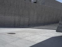 this is a picture of a large concrete block wall that stretches over the top of the sidewalk