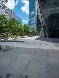 there are some buildings near each other and the ground has paving tiles on it and trees around