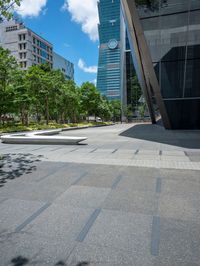 there are some buildings near each other and the ground has paving tiles on it and trees around