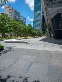 there are some buildings near each other and the ground has paving tiles on it and trees around