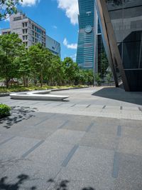 there are some buildings near each other and the ground has paving tiles on it and trees around