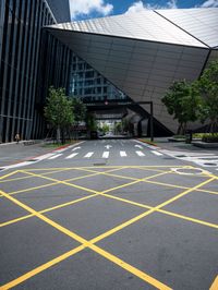 an asphalt parking lot with yellow lines painted all over it in front of the building