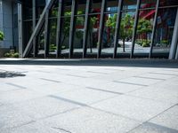 the person is sitting on a bench outside in a city building and riding a skateboard