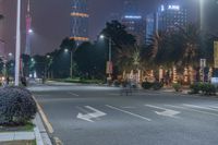 a city street with buildings and neon lights at night time in hong china as seen from an empty city highway