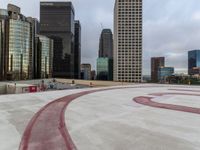 the roof of an apartment building with a circle and large numbers painted on it near some buildings