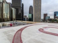 the roof of an apartment building with a circle and large numbers painted on it near some buildings