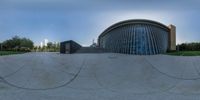 a round photo with lines across it of a building in the background, as seen through a panoramic lens