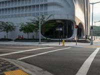 an intersection has traffic lights and building next to it for a pedestrian or cyclist crossing