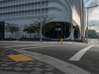 an intersection has traffic lights and building next to it for a pedestrian or cyclist crossing