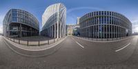 three circular views of a futuristic city in perspective and with the street between them on a clear day