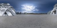 a fisheye picture with white structures and a blue sky in the background, while it shows an angle and is very wide