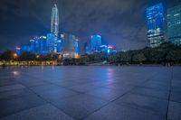 city skyline in the distance with square paving with lights on the ground in the foreground