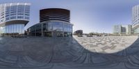 the circular picture is shown with two buildings in the background and another building behind it