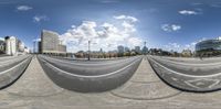 this is a fisheye panoramic view of a cityscape in a 360 camera lens