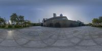 a view of some concrete architecture with the sunlight peeking through it, from a fisheye lens