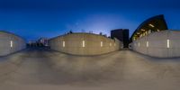 two identical images of skateboarders inside concrete structure at night time, as seen in fisheye lens