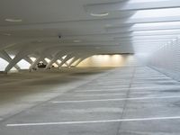 a picture of an empty and parking garage with an empty floor inside of it a car parked in the garage