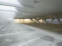 a picture of an empty and parking garage with an empty floor inside of it a car parked in the garage