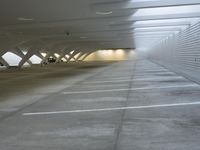 a picture of an empty and parking garage with an empty floor inside of it a car parked in the garage