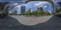 a very long curved building is shown through the lens of it's reflection on the ground