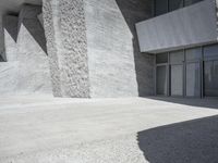 this is an outdoor courtyard with stone steps and a curved concrete wall, that stretches to the outside