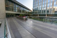 there is a bench on this floor outside a building in this picture that appears to be empty