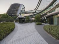 the circular walkway of an office building in a city, leading up to a large circular staircase