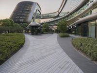 the circular walkway of an office building in a city, leading up to a large circular staircase