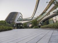 the circular walkway of an office building in a city, leading up to a large circular staircase
