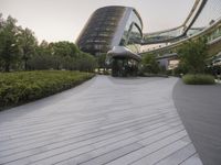 the circular walkway of an office building in a city, leading up to a large circular staircase