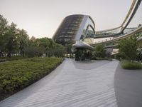 the circular walkway of an office building in a city, leading up to a large circular staircase