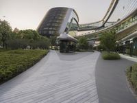 the circular walkway of an office building in a city, leading up to a large circular staircase