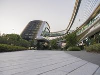 the circular walkway of an office building in a city, leading up to a large circular staircase