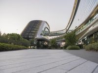 the circular walkway of an office building in a city, leading up to a large circular staircase