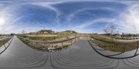 two fisheye images of a pedestrian bridge in the park at the end of a long stretch of walkway