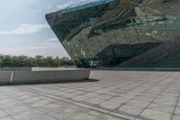 a person that is on some kind of concrete sidewalk with a cell phone in his hand