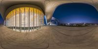 fish eye view of a large modern building at night with no one else in it