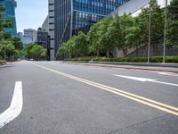 a road with trees and buildings in the background on a clear day in a big city