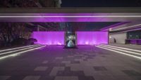 purple lighting illuminate a square shaped building at night, with sculptures sitting in front