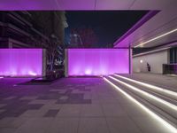 purple lights inside of a building with steps and stone floors and tiled flooring around it